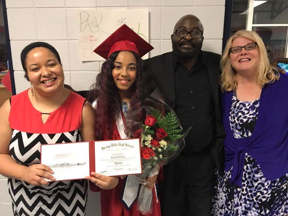 Family poses with high school graduate